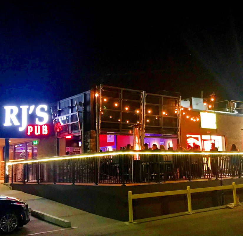 RJ’s Pub and its outdoor patio lit up in the evening